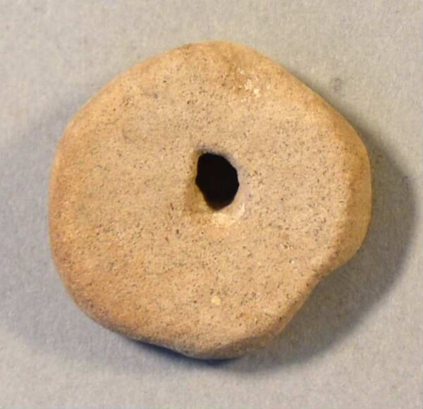 pierced stone disc