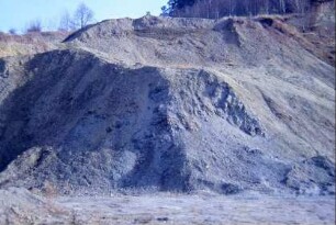 Ziegelei, Haufen zerkleinerten Lehms und Tons, dahinter Lehmgrube