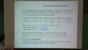 Minimizing movement approach using general level set functions for evolving spirals by crystalline curvature flow