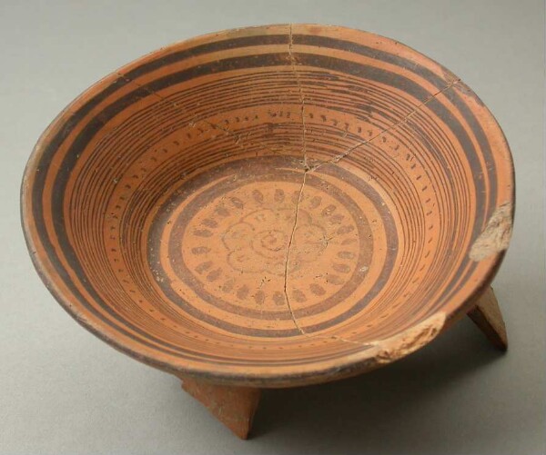 Three-footed clay bowl