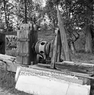 Drahtmühle: Restaurierung: Mühlenwerk der Papiermühle mit Holzbohlen: vorn Stapel mit Brettern: dahinter Bäume
