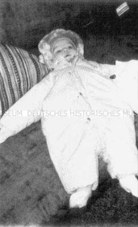 Fotoeffekt, liegendes Baby in einem Schneeanzug( Altersgruppe 14-17)