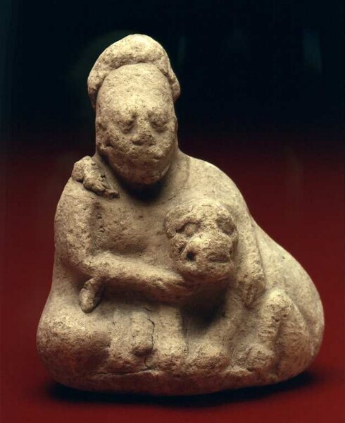 Depiction of "human with dog in arms"