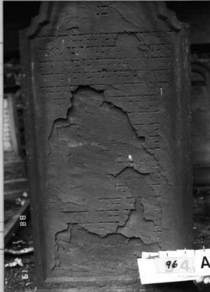 Grabstein 96 (Index: 100094804) Material: Sandstein Zustand: abgeblättert mit Textverlust Maße HxBxT: 168x75x19 cm Beschreibung: Stele, doppelt eingezogener Rundbogenabschluß, Schriftfeld eingetieft: Grabstein 96A