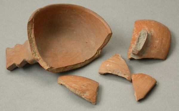 Three-footed clay bowl