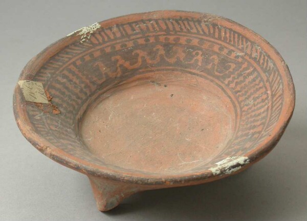 Three-footed clay bowl