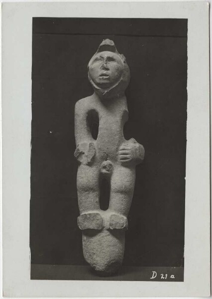 Male stone figure with bird helmet mask, front view. (Arm and smaller parts broken off). Guillermo de Heredia Collection.