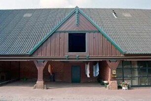 Fritz-Berodt-Straße 7-9: Hofanlage: Haus Nr. 7 [Haus am Teich]: Traufseite zum Hof, Teilansicht: ehemalige Remise mit Holzständern, darüber Frontispiz mit Verbretterung, Luke, oben Giebelzier, rechts moderner Eingangsbereich mit Verglasung: 21. Oktober 1993