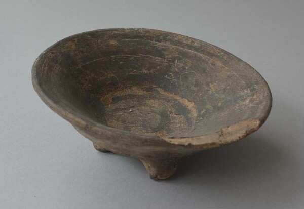 Three-footed clay bowl