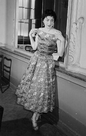 Modeaufnahmen, Frau im eleganten Kleid vor einem Spiegel