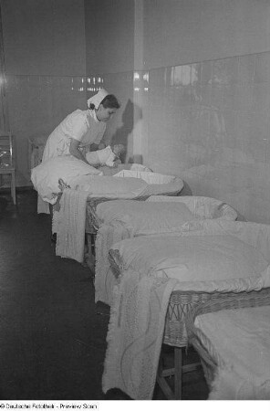 Krankenschwester mit Neugeborenem auf der Säuglingsstation