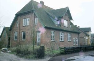 Hauptstraße 44: traufständiges Backsteinhaus: Straßenfront mit Zwerchgiebel: Giebelseite mit Tür
