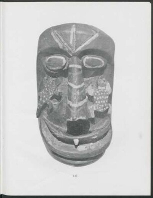 [Photograph of profile of mask] : Hewn from a tree trunk and painted black, with red and white stripes. Lizard on one cheek and frog on the other, painted green.