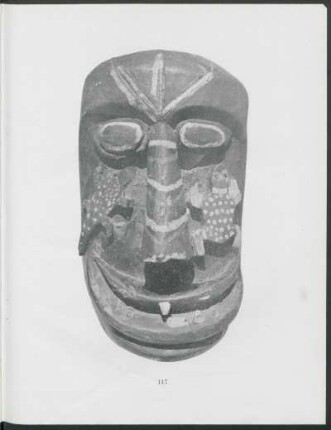 [Photograph of profile of mask] : Hewn from a tree trunk and painted black, with red and white stripes. Lizard on one cheek and frog on the other, painted green.