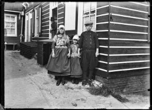 Niederlande, Marken. Kinder in Tracht und Uniform vor einem Wohnhaus