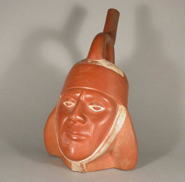 Portrait head with stirrup spout