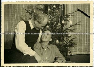 Vater und Tochter vor dem Weihnachtsbaum