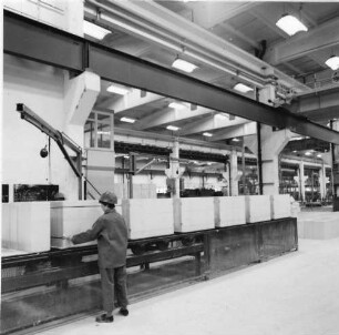 Eilenburg, Dübener Landstraße. VEB Betonwerk Laußig, Betriebsteil Betonwerk Eilenburg. Werkhalle. Paketierung. Arbeiterin an einer Bandanlage