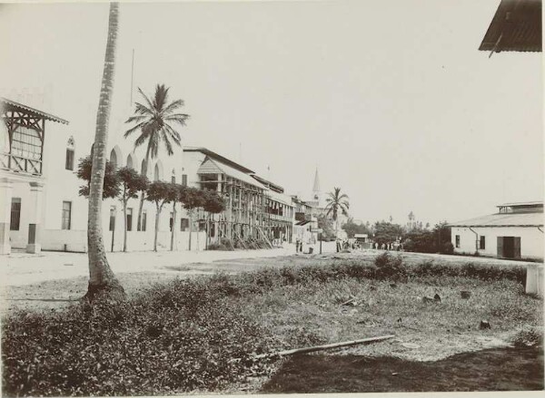 Street with buildings, church and people