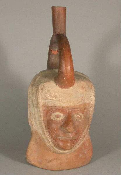 Figure vessel with stirrup spout