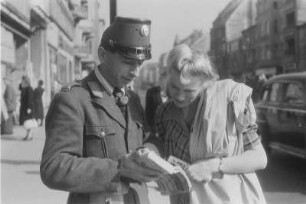 Berlin. Polizist erklärt einer jungen Frau etwas