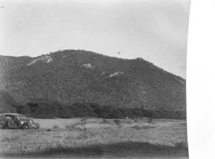 Berg : Fahrzeug auf einem Feld am Fuße eines Berges