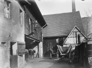 Coswig. Wohnstallhaus und Stallgebäude eines Bauernhofes. Hofansicht mit Leiterwagen