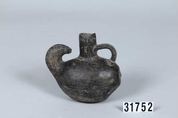 Handled vessel in the shape of a fruit