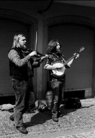 Freiburg: Münsterplatz, zwei Straßenmusikanten von vorne, Geige, Banjo