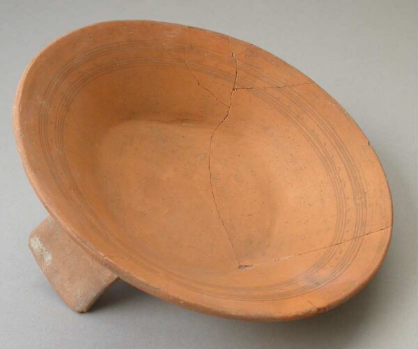 Three-footed clay bowl