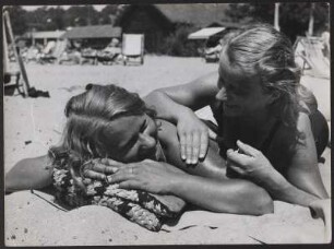 Zwei Frauen liegen am Strand