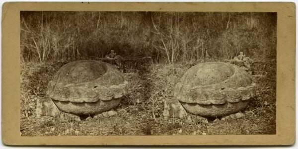 Sacrificial stone from the large square. It is surrounded on the side by a spiral-shaped ornament. A groove is engraved on the top.