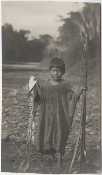 Chimane boy with caught fish