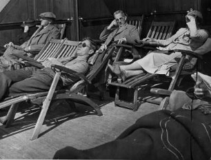 An Deck des Passagierschiffes "Hansestadt Danzig" des Seedienstes Ostpreußen. Passagiere liegen auf Liegestühlen in der Sonne