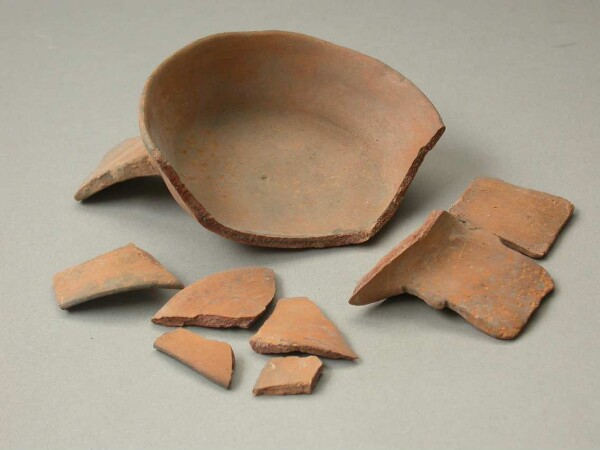 Three-footed clay bowl