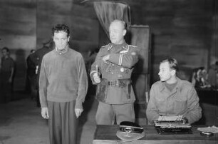 Szenenbilder aus dem Drama "Der Gesang im Feuerofen" von Carl Zuckmayer am Schillertheater Berlin : Szene mit Peter Mosbacher (vorne, links) und Carl Kuhlmann als Catonnier (vorne, Mitte)