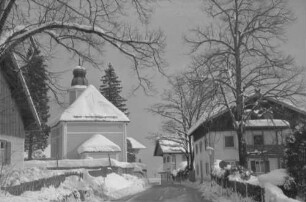 Walchensee: Straße mit verschneiten Häusern, mit Kirche