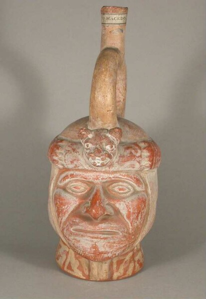 Figure vessel with stirrup spout