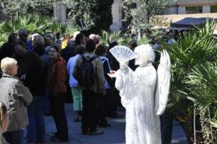 Barcelona - Als Engel verkleidete Frau bettelt : Eine als Engel verkleidete Frau bettelt vor der Kathedrale. Aufgenommen am 15. April 2012 in Barcelona