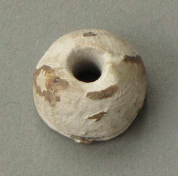 Spin whorl (?) or shell bead (?)