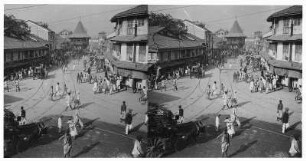 Bombay, Indien. Geschäftsstraße mit Passanten von erhöhtem Standpunkt an einer Kreuzung gegen Turmbau