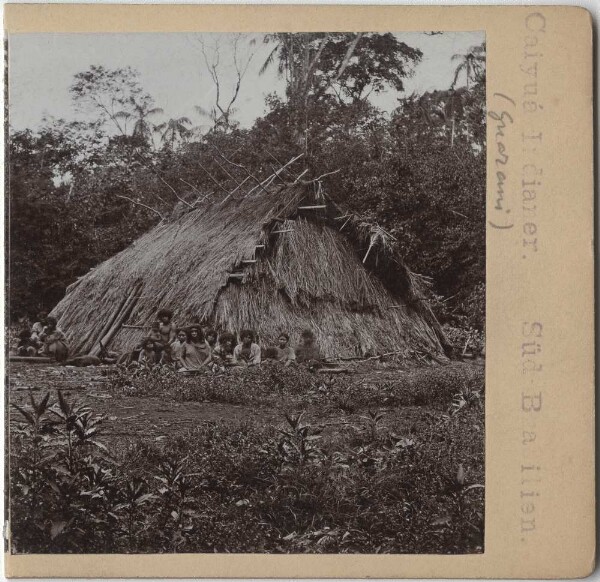 Group of people in front of a hut