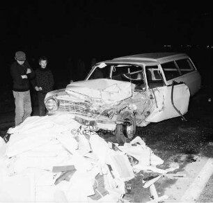 B 404: bei Tralau: Verkehrsunfall: Zusammenstoß von Pkw-Kombi mit Lkw: Pkw-Kombi mit eingedrückter Front: davor auf Fahrbahn zahlreiche Pakete von Ladung: links zwei Jungen als Zuschauer: im Dunkeln, 12. Januar 1965