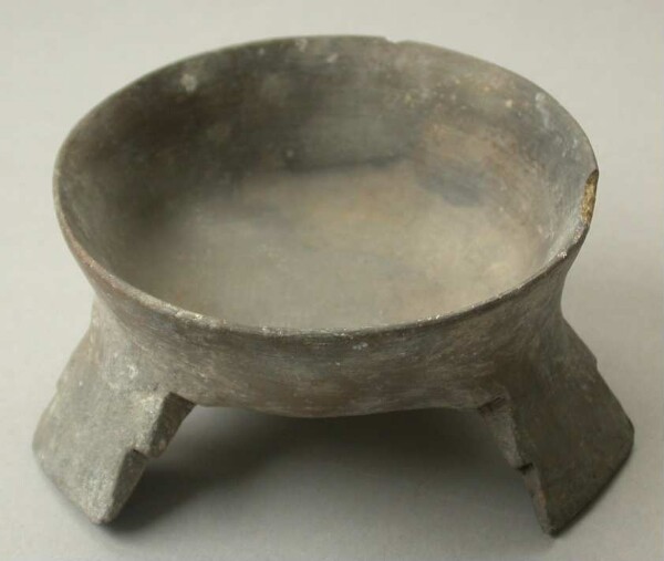 Three-footed clay bowl