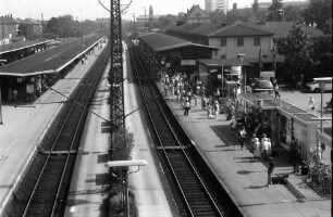 Freiburg: Gleis 1 ohne Zug mit wartenden Leuten; Gleis 2 von der Stadtbahnbrücke