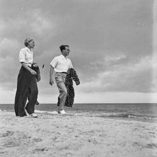 Ein Paar spaziert am Strand entlang