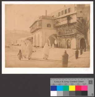 Veiled women walking along the port of Algiers below the ramps of the Boulevard de la Republique