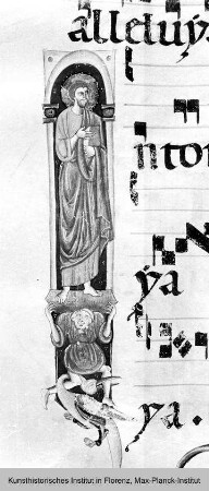 Antiphonar : Textseite mit vierzeiligen Neumen und Miniatur in der Randleiste: Prophet wird von einem Atlanten gestützt