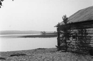 Hütte am See : Blockhütte am Ufer eines Gewässers.