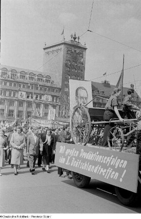 Blick auf einen Festwagen im Demonstrationszug, im Hintergrund das Kroch-Hochhaus
